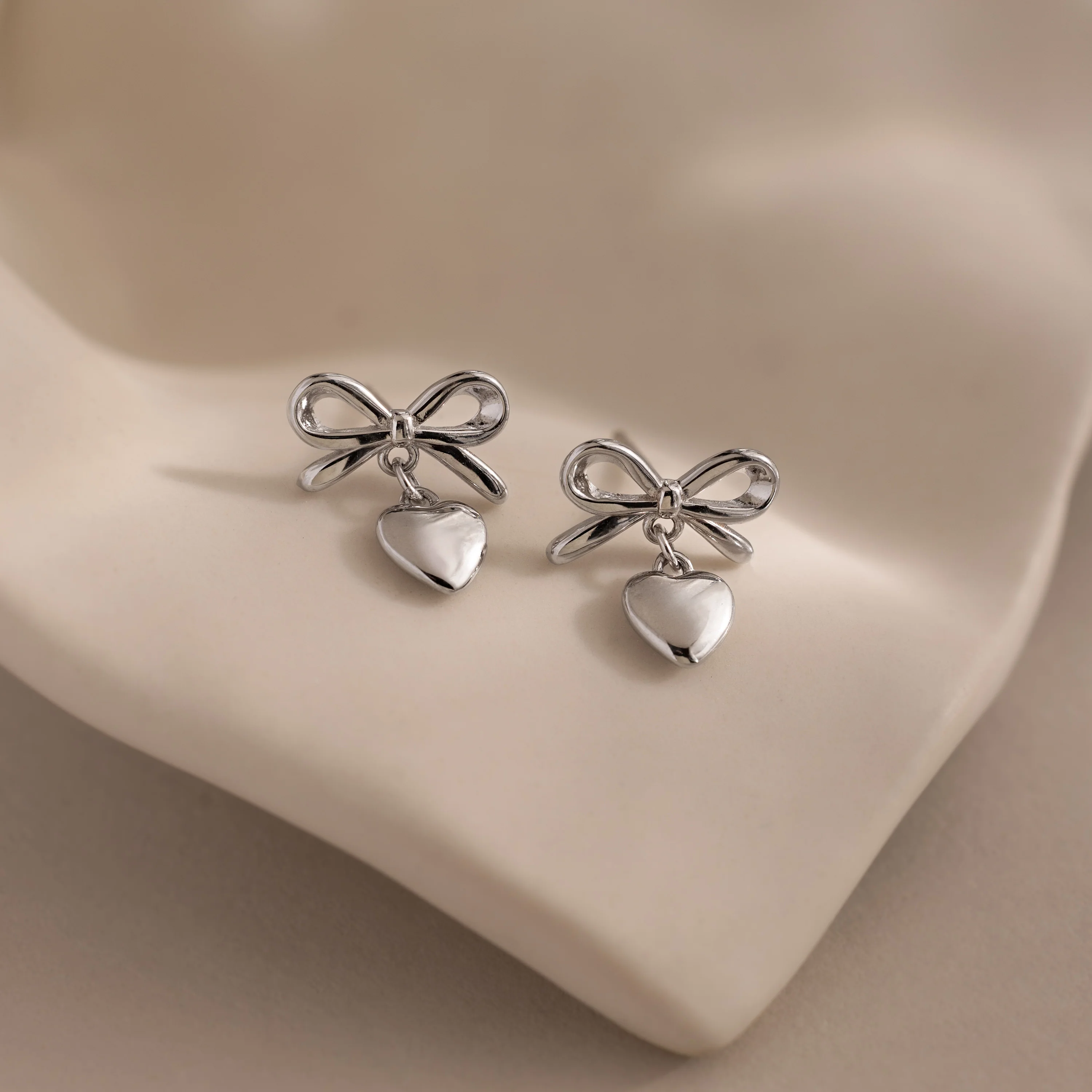 Bow Heart Studs in Silver